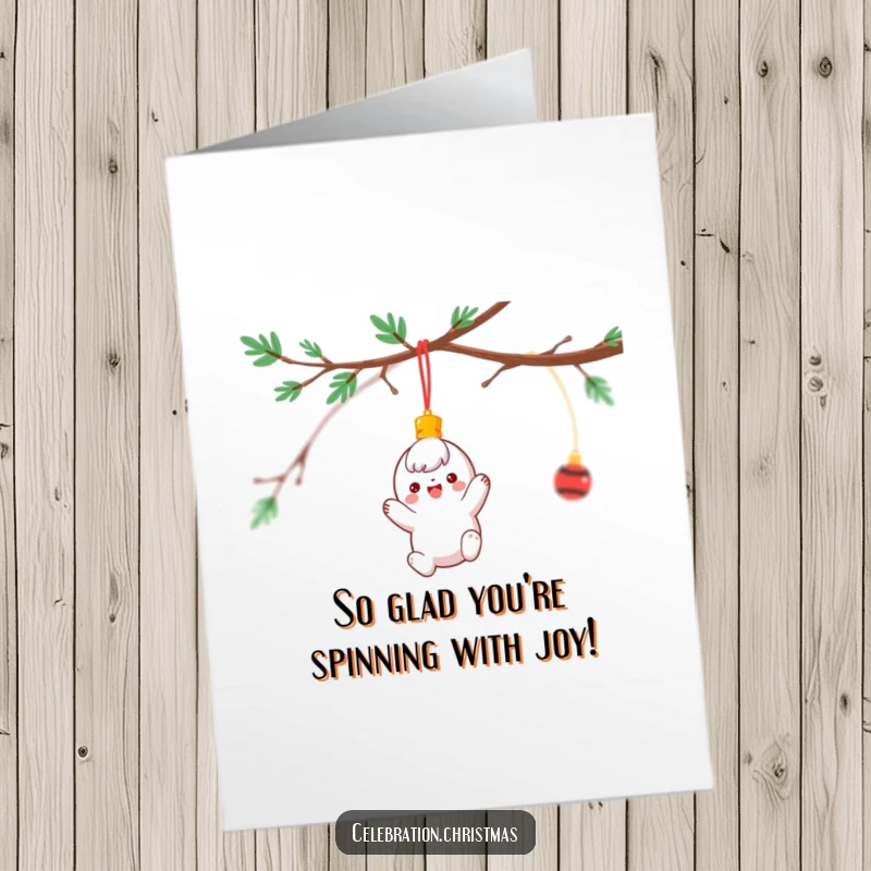 Funny Free Printable Birthday Card showing a cheerful ornament character dangling and spinning wildly from a festive branch.