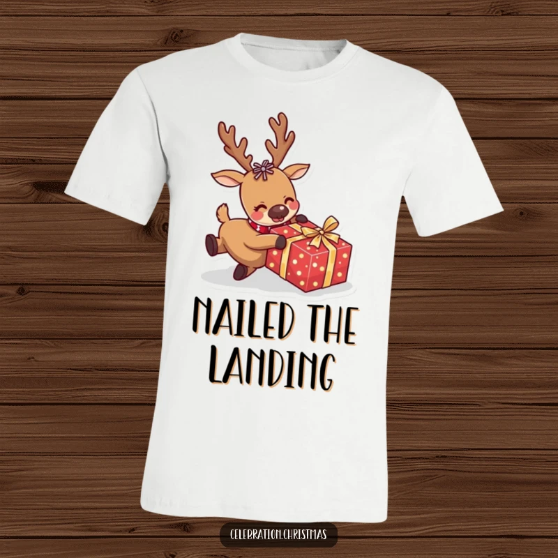 Funny reindeer t-shirt depicting a comical fall over a wrapped present, ideal for bringing holiday humor and laughter to any occasion.